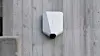 White Easee charger mounted on concrete wall